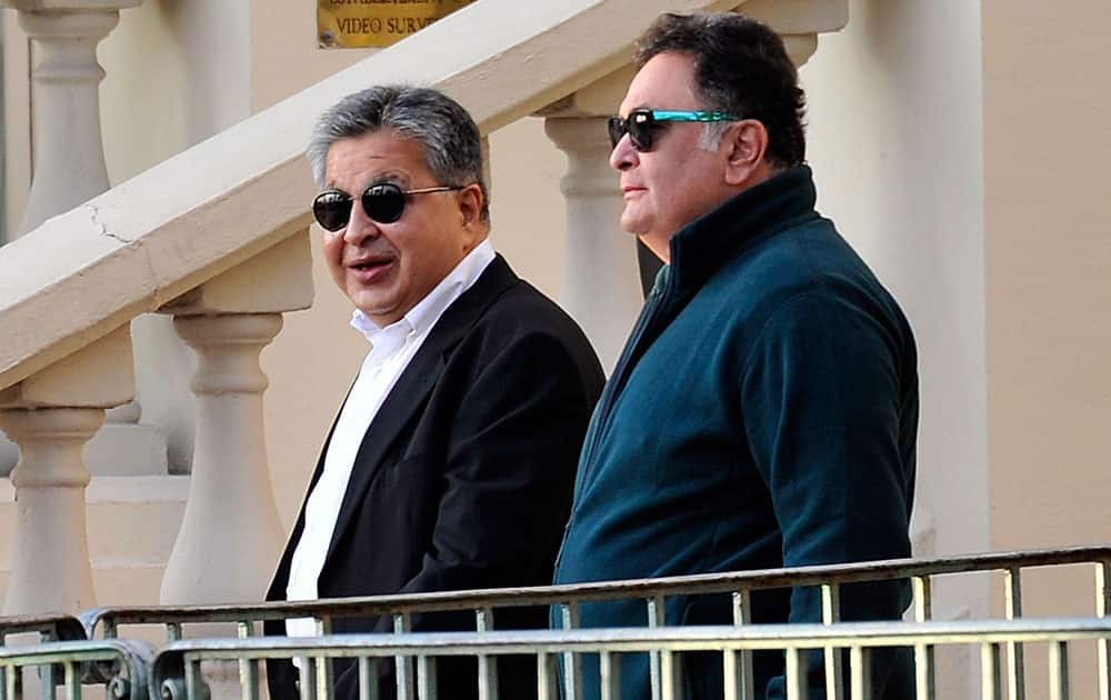 Bollywood actor Rishi Kapoor leaves the Carlton hotel along with an unidentified friend prior to the wedding parade of Kunal Grover, son of London-based industrialists Kimi and Pamela Grover, in Cannes, southern France.