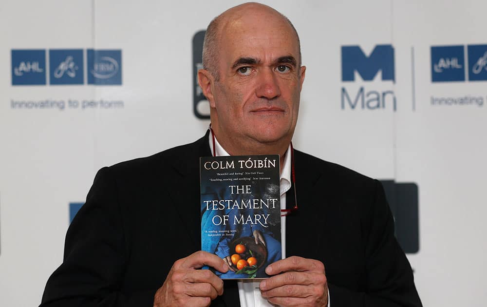 Irish author Colm Toibin poses with his book 'The Testament of Mary' during a photocall for the shortlisted authors of the 2013 Man Booker Prize for Fiction at the Queen Elizabeth Hall in London.