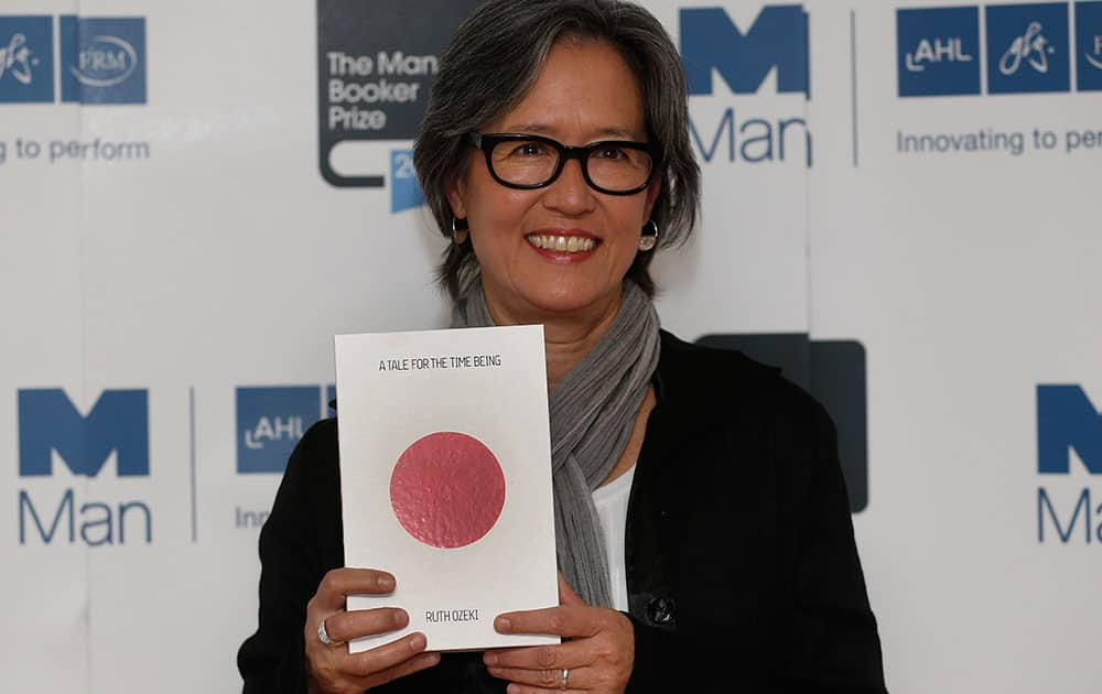 United States author Ruth Ozeki poses with her book 'A Tale for the Time Being' during a photocall for the shortlisted authors of the 2013 Man Booker Prize for Fiction at the Queen Elizabeth Hall in London.