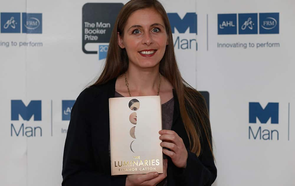 New Zealand author Eleanor Catton poses with her book 'The Luminaries' during a photocall for the shortlisted authors of the 2013 Man Booker Prize for Fiction at the Queen Elizabeth Hall in London.