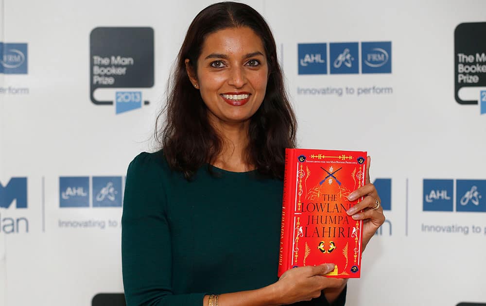 United States author Jhumpa Lahiri poses with her book 'The Lowland' during a photocall for the shortlisted authors of the 2013 Man Booker Prize for Fiction at the Queen Elizabeth Hall in London.