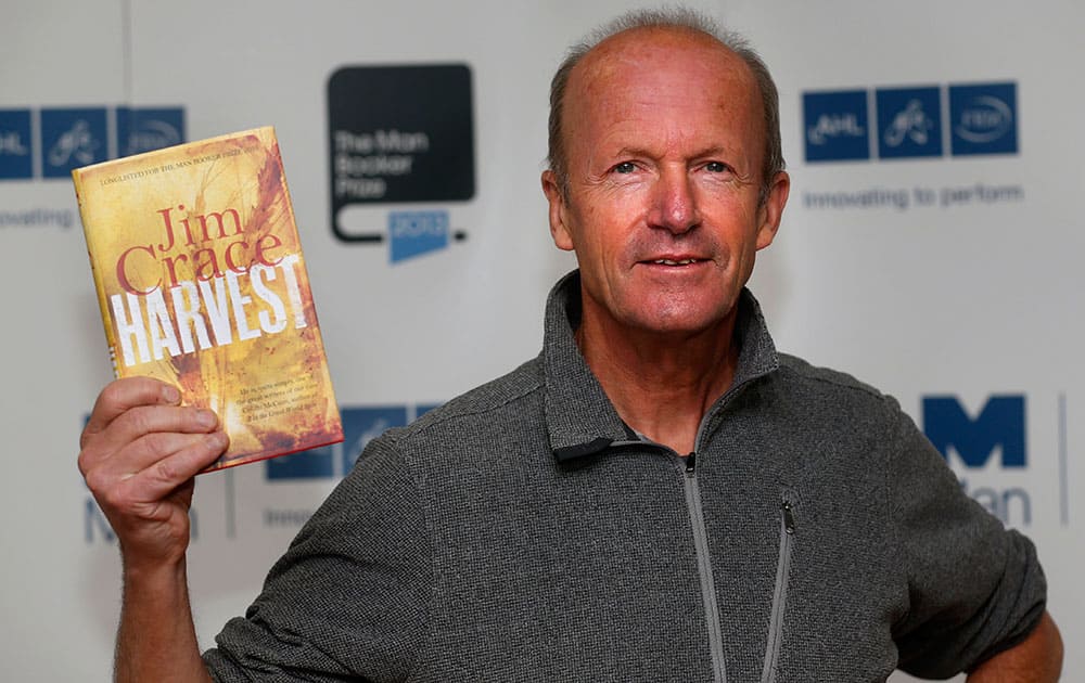 British author Jim Crace poses with his book 'Harvest' during a photocall for the shortlisted authors of the 2013 Man Booker Prize for Fiction at the Queen Elizabeth Hall in London.