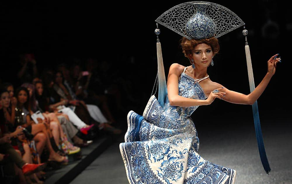 A model showcases an outfit by Chinese fashion design Guo Pei, in Singapore during the Fide Fashion Week 2013 Asian Couture show.