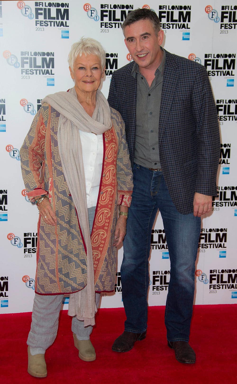 British actors Steve Coogan, right, and Judi Dench pose together during a photo call for Philomena, as part of the 57th BFI London Film Festival, at a central London cinema.