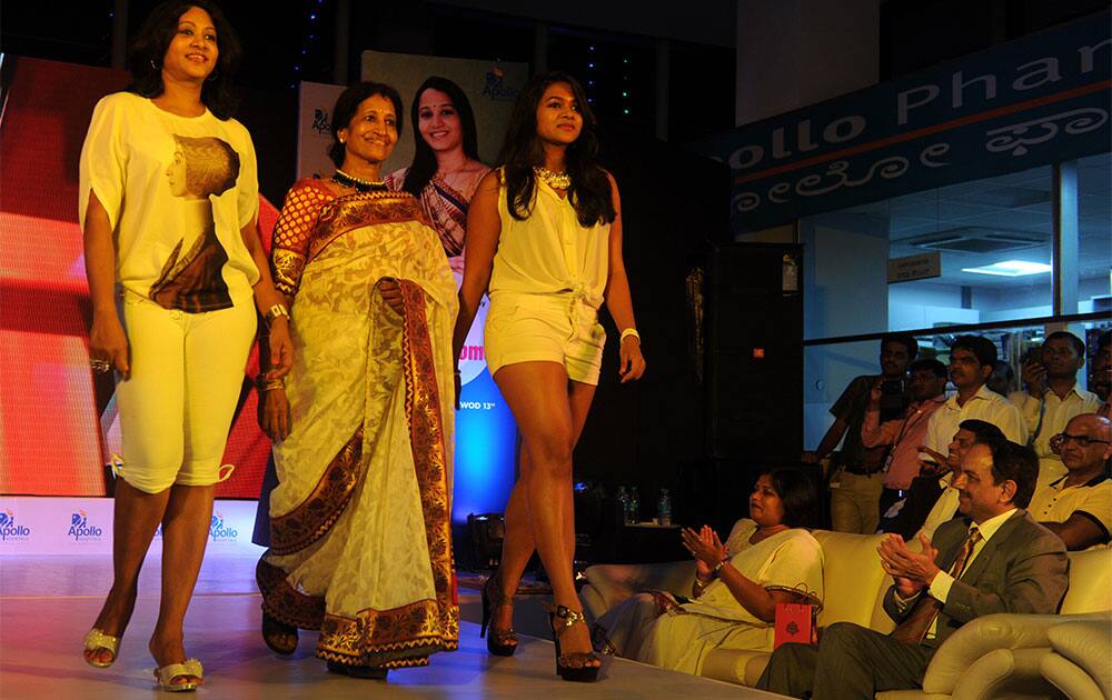 Mothers and daughters participating in a fashion show at a programme 