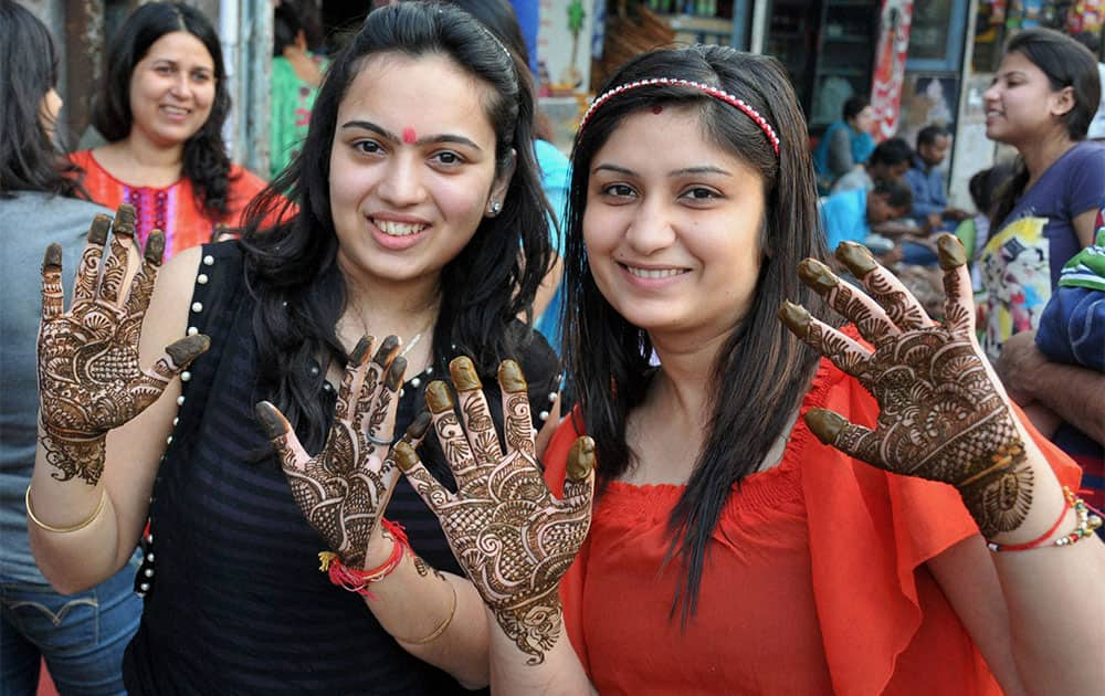 Women applying 'mehandi' ahead of 'Karva Chauth' in Indore.