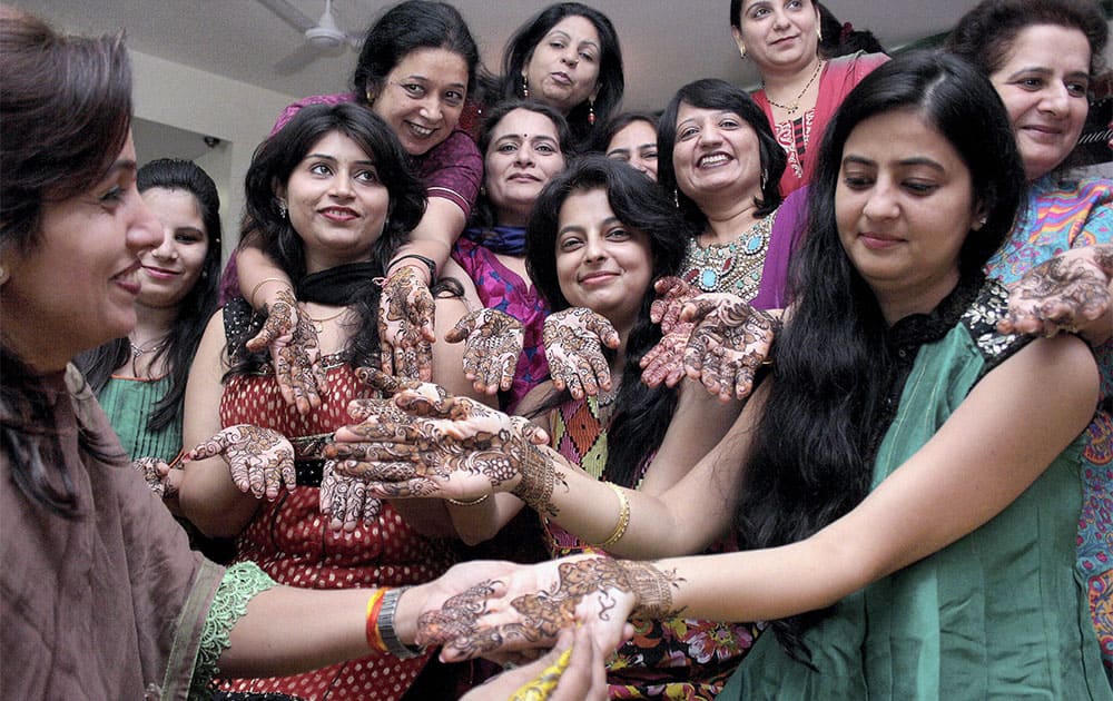 Women with 'mehandi' on their hands ahead of 'Karva Chauth' in Indore.