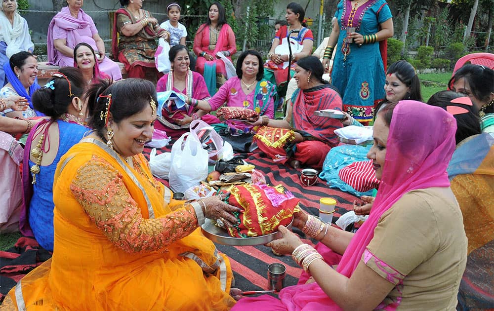 Women perform rituals as they celebrate 'Karva Chauth' in Amritsar.