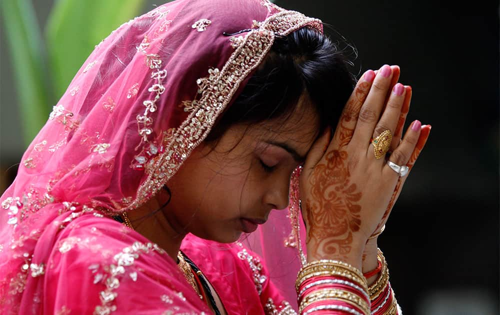 A married Hindu woman performs rituals on Karwa Chauth festival, in Allahabad.