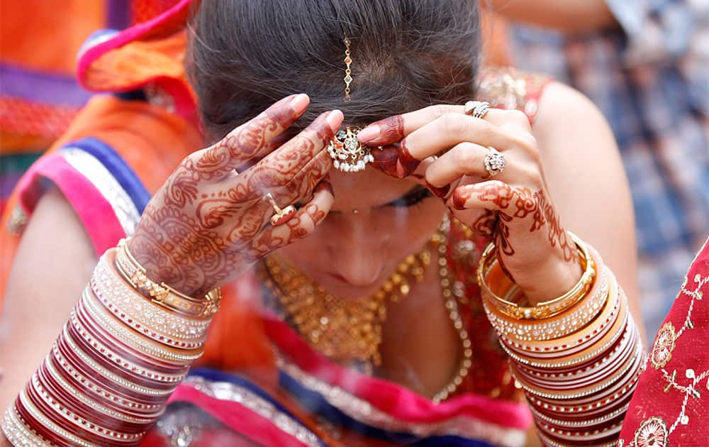 A married Hindu woman performs rituals on Karwa Chauth festival, in Allahabad.