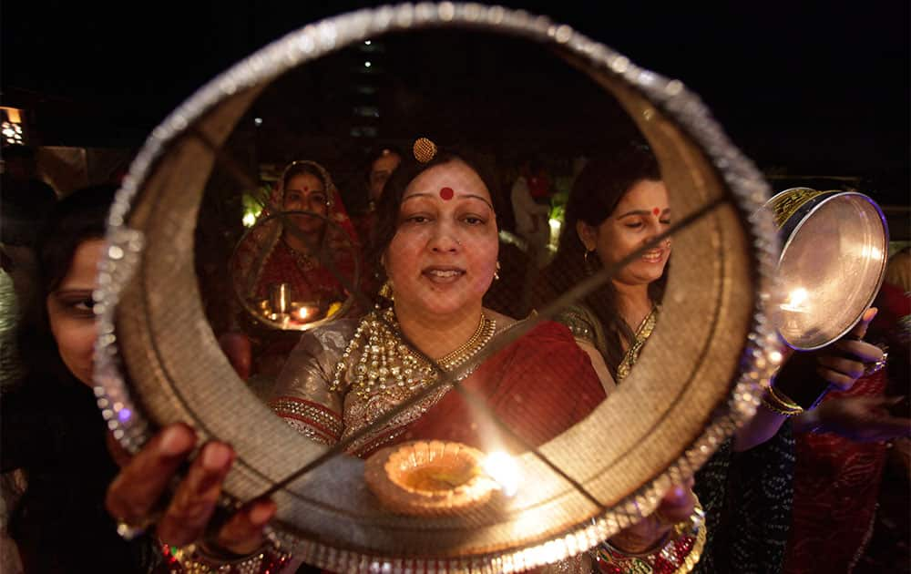 Married Hindu women perform rituals during 'Karwa Chauth' festival, in Ahmadabad.