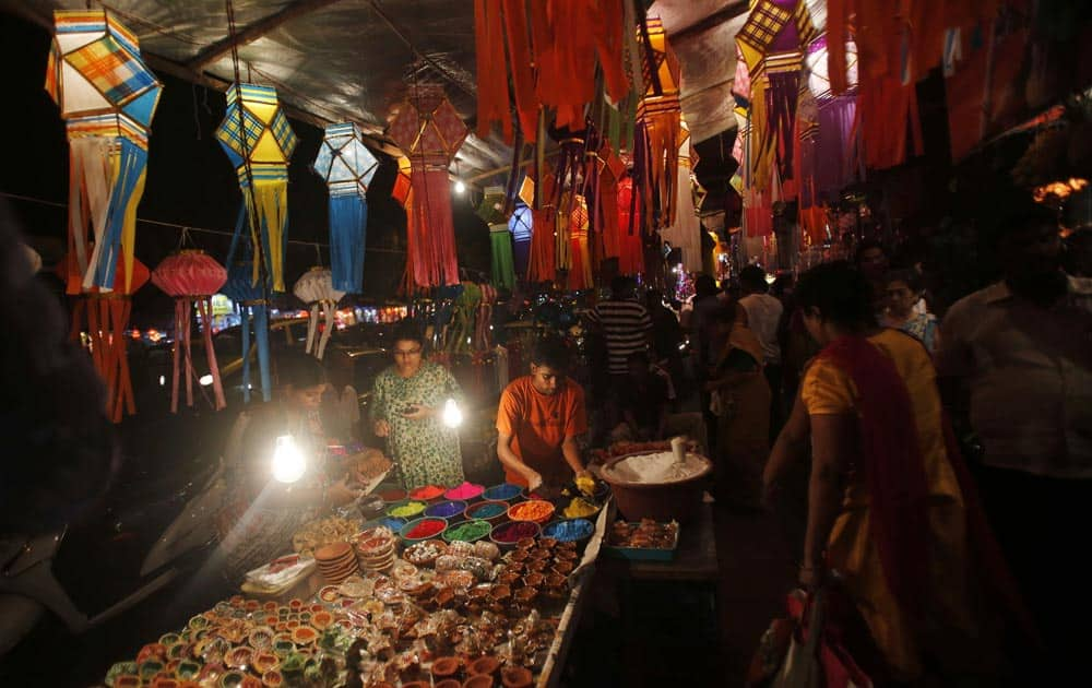 People buy lanterns and other decorative items from roadside stalls ahead of Hindu festival of lights Diwali, in Mumbai.