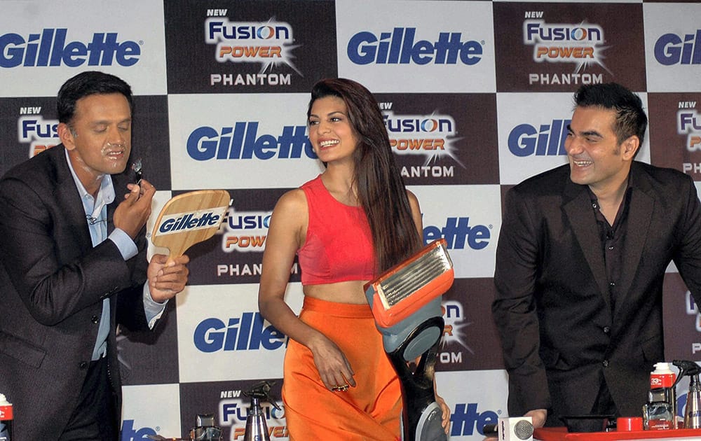 Cricketer Rahul Darvid shaves as Bollywood actors Jacqueline Fernandis and Arbaaz Khan during the launch of a new fusion power Phantom razor in Mumbai.