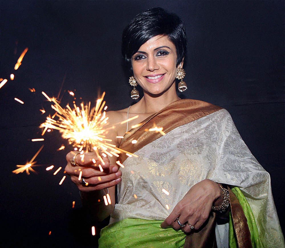 Bollywood actress, model and television anchor Mandira Bedi celebrates Diwali during the opening of her new designer store in Mumbai .