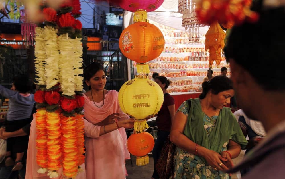 Women shop for artificial garlands ahead of Diwali in Allahabad.