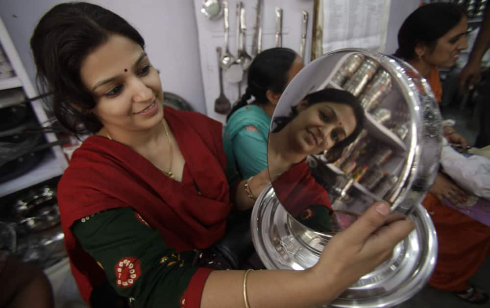 A woman shops for utensils during Dhanteras, which marks the beginning of Hindu festival of lights Diwali, in Jammu.