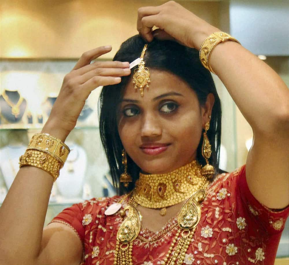 A woman with gold ornaments at a jwellery shop on the occasion of Dhanteras in Jamshedpur.