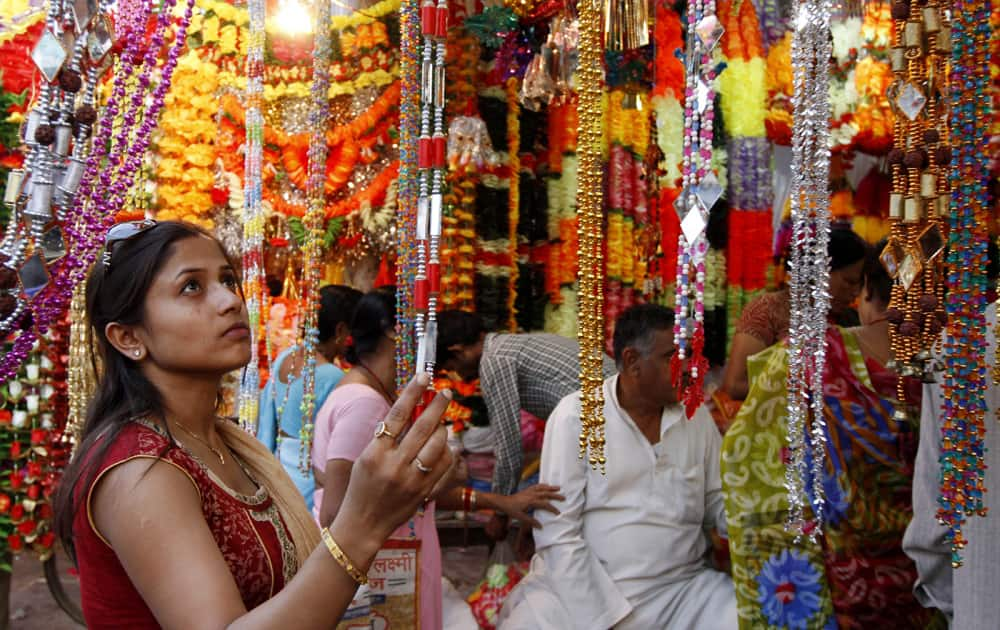 A woman shops for artificial garlands ahead of Diwali in Allahabad.