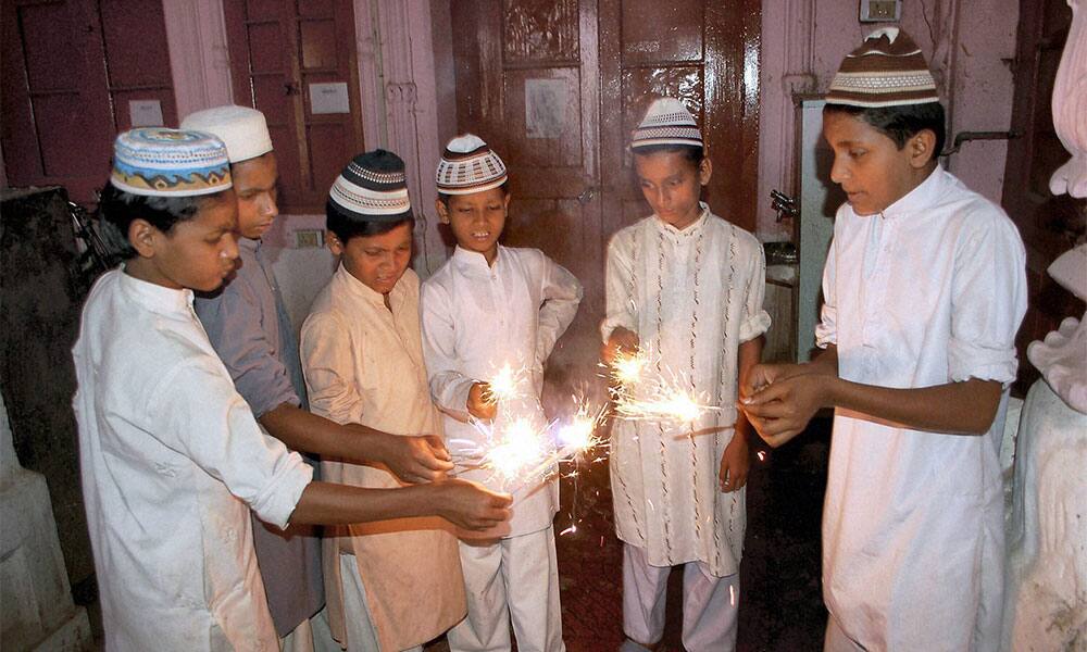 Muslim children celebrating Diwali with sparklers at a Madarsa in Mirzapur.