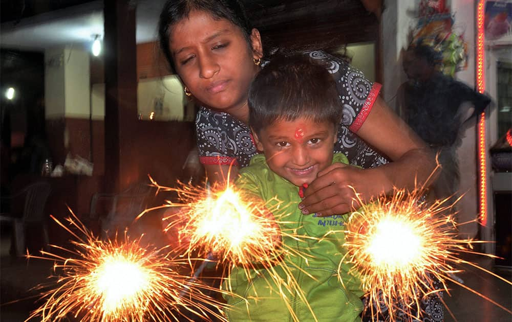 A child celebrating Diwali by lighting fire crackers in Bikaner.