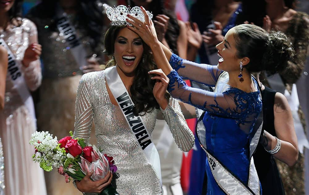 Miss Universe 2012 Olivia Culpo, from the United States, right, places the crown on Miss Venezuela Gabriela Isler during the 2013 Miss Universe pageant in Moscow, Russia.