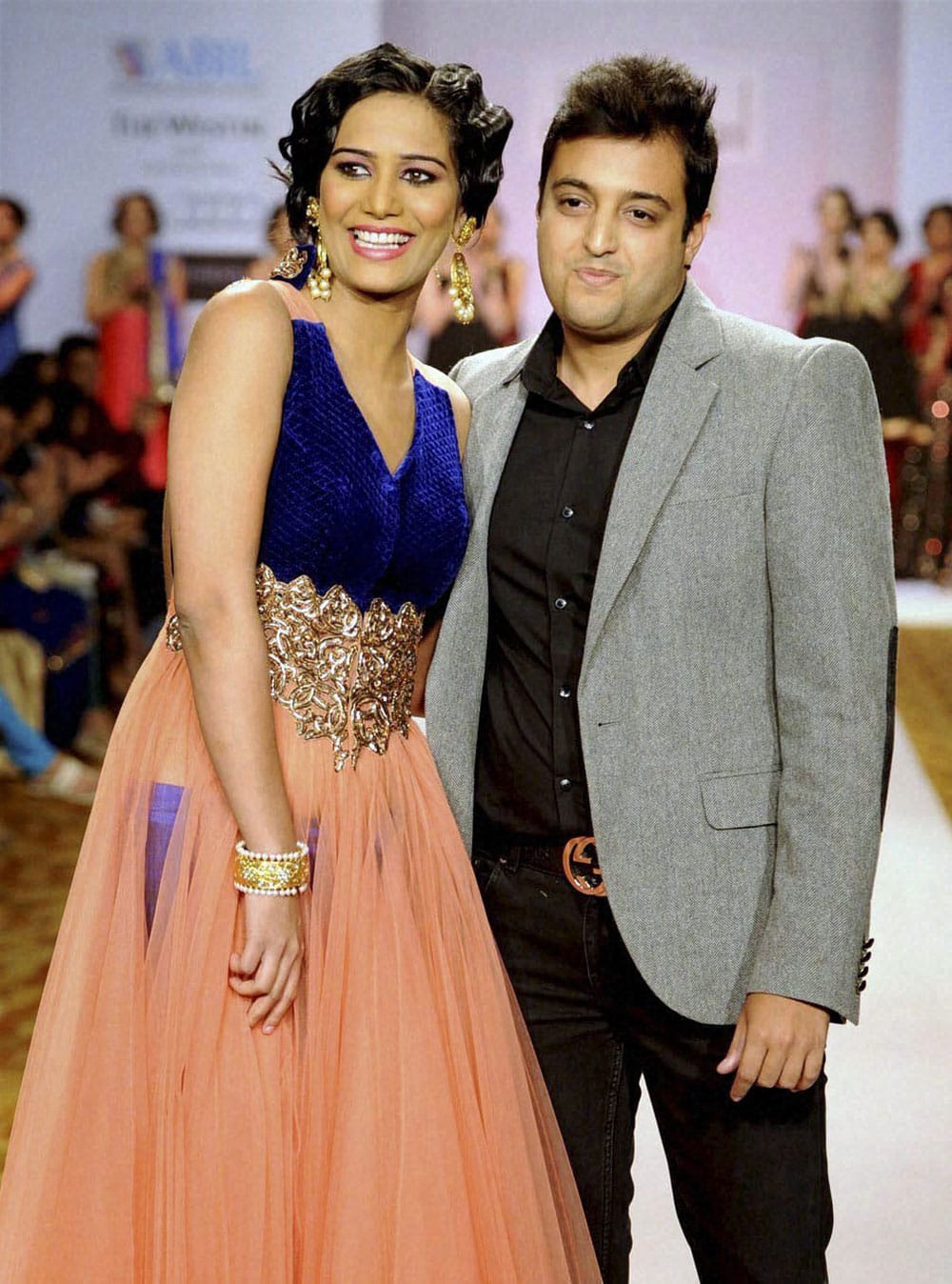 Model actress Poonam Pandey with designer Dinesh Malkani at the ramp during the Pune Fashion Week in Pune.