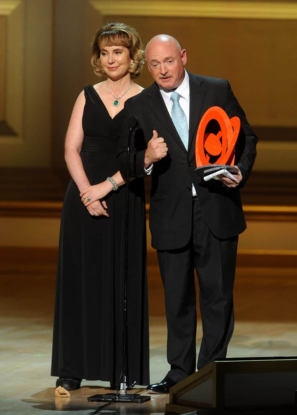 US Representative Garbrielle Giffords and husband Retired US Navy Captain and NASA Astronaut Mark Kelly accept The Couple of the Year Award on stage at the 2013 Glamour Women of the Year Awards.