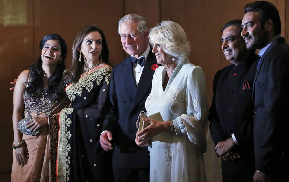 Britain's Prince Charles and his wife Camilla, the Duchess of Cornwall, stand with Bollywood actress Kajol, businesswoman Nita Ambani, industrialist Mukesh Ambani and Bollywood actor Ajay Devgan before a dinner to support the work of British Asian Trust in Mumbai.