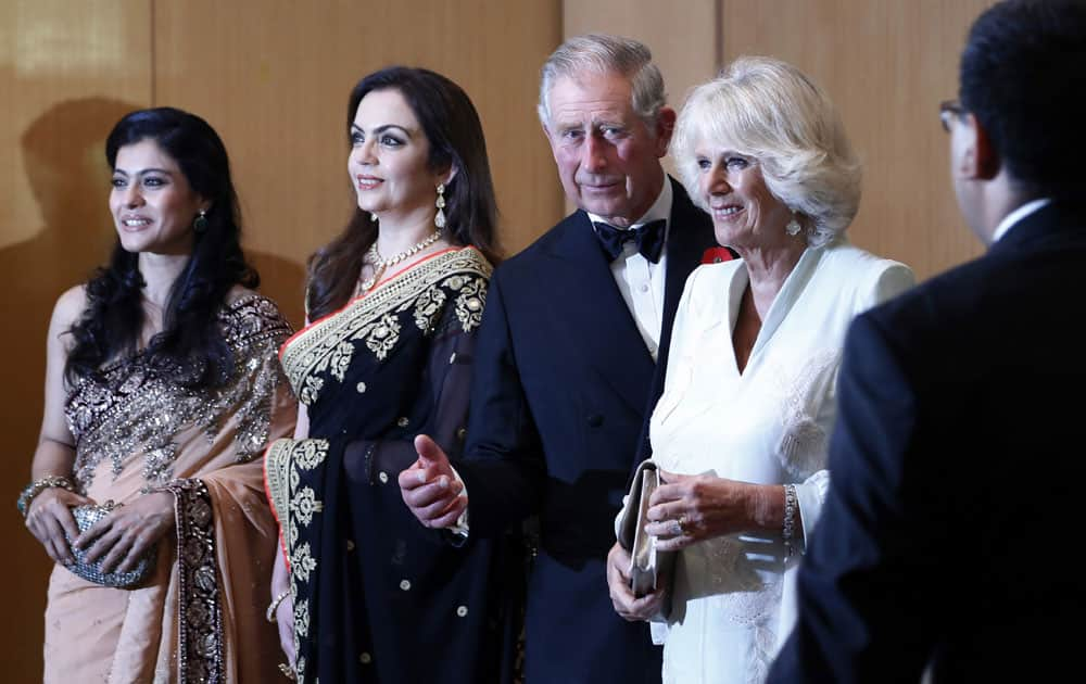 Britain's Prince Charles and his wife Camilla, the Duchess of Cornwall, stand with Bollywood actress Kajol, businesswoman Nita Ambani, industrialist Mukesh Ambani and Bollywood actor Ajay Devgan before a dinner to support the work of British Asian Trust in Mumbai.