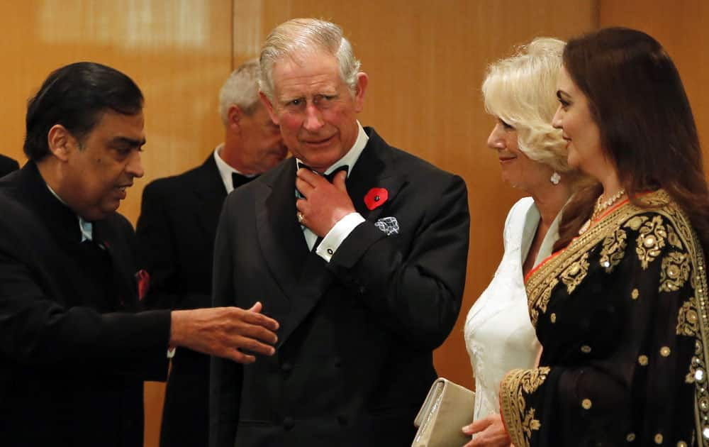 Britain's Prince Charles and his wife Camilla, the Duchess of Cornwall, stand with industrialist Mukesh Ambani and his wife Nita Ambani before a dinner to support the work of British Asian Trust in Mumbai.