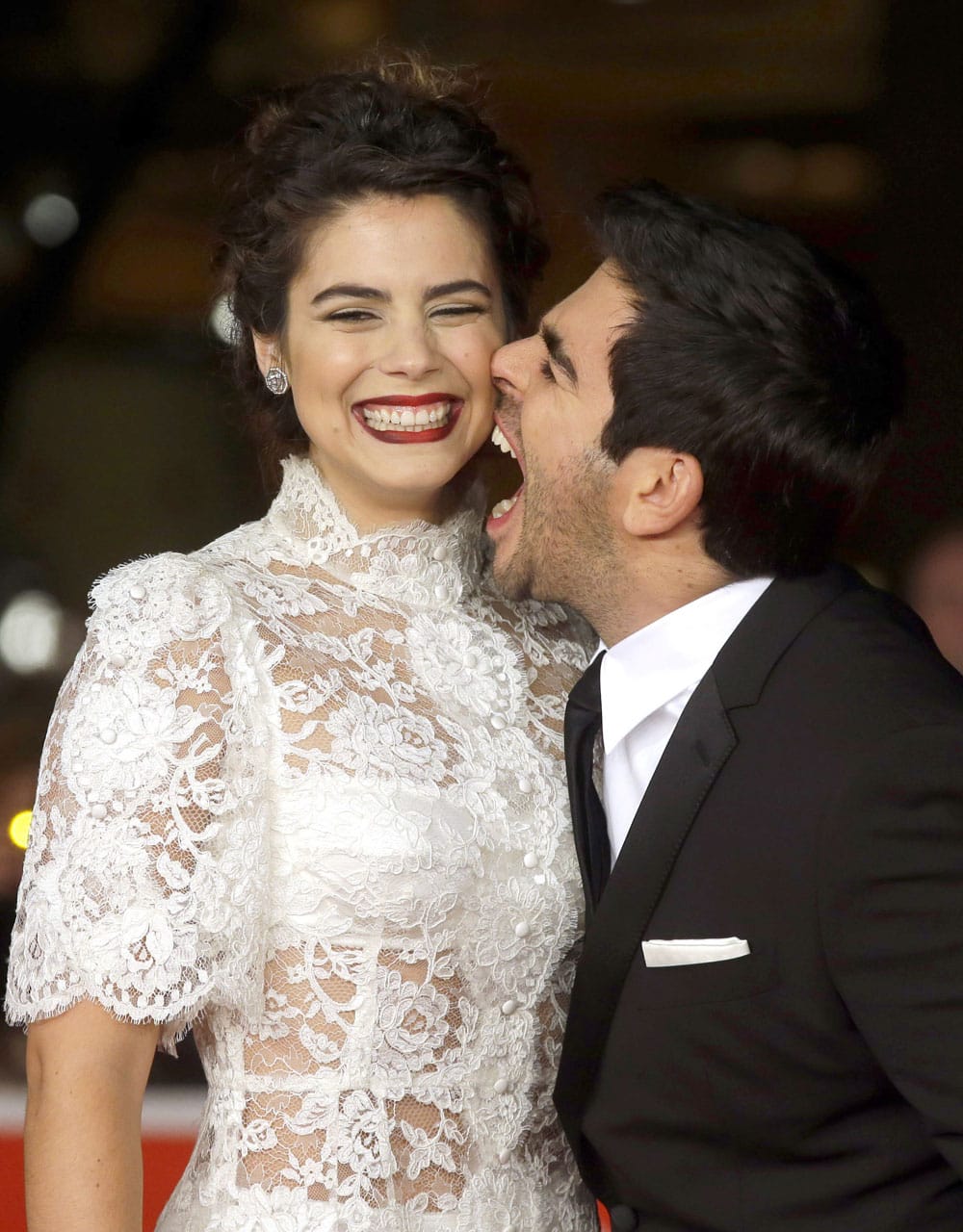 Director Eli Roth, right, pretends to bite actress Lorenza Izzo as they arrive for the red carpet of the movie 'The Green Inferno', at the 8th edition of the Rome International Film Festival, in Rome.