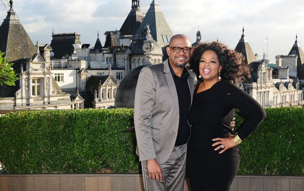 US actors Forest Whitaker, centre and Oprah Winfrey pose for photographers, during a photo call for the film, 'The Butler', at Corinthia Hotel in London.