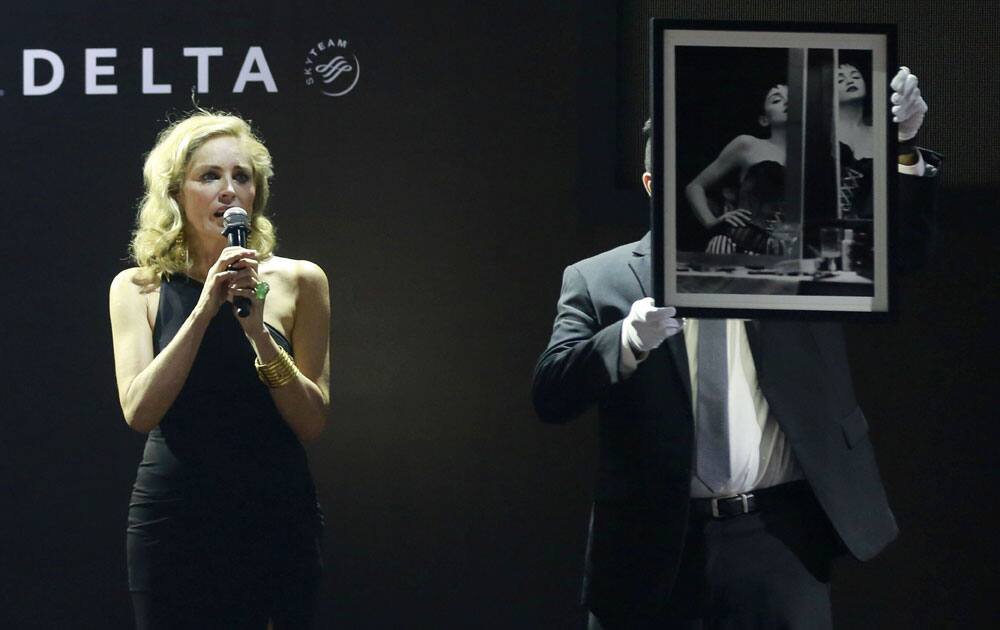 Hollywood actor Sharon Stone, left, auctions off a photograph of Madonna during an auction event at the amfAR (The Foundations for AIDS research) India’s inaugural fundraising gala in Mumbai, India.