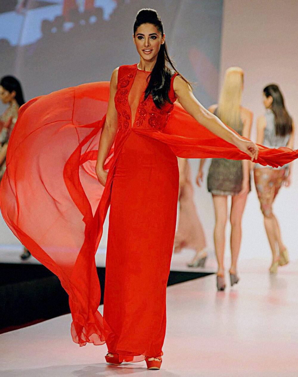 Bollywood actress Nargis Fakhri walks the ramp at Signature International Fashion Week 2013 in Mumbai.