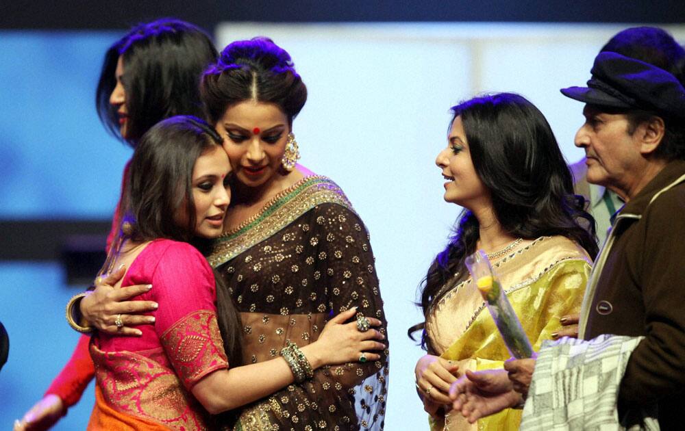 Bollywood actress Rani Mukherjee and Bipasha Basu hugs each other,while Susmita sen passes out at the backdrops and Tollywood actress Koel Mallick and Veteran actor Biswajit looks on during 19th Kolkata International Film Festival in Kolkata.