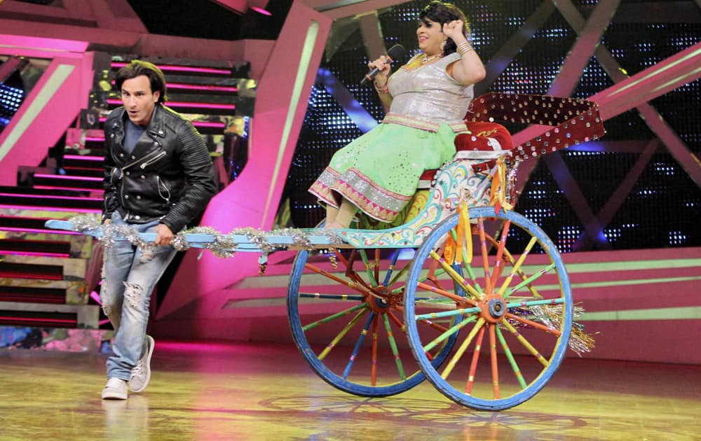 Saif Ali Khan performs with a participant on the sets of a TV show to promote his upcoming film 'Bullet Raja' in Mumbai.