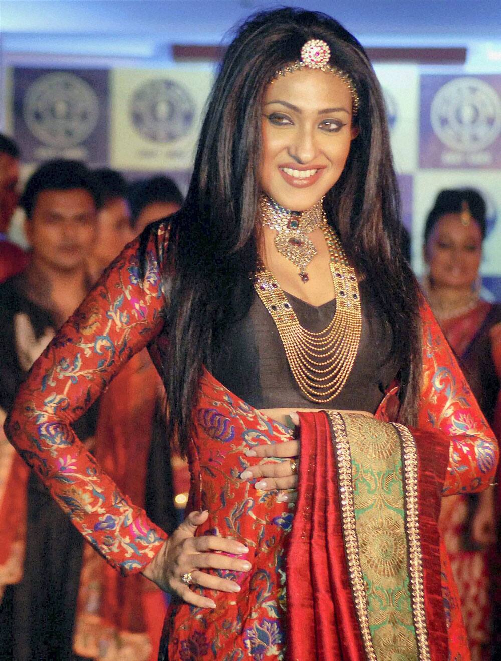 Tollywood actress Rituparna Sengupta walks the ramp during a promotional event in Kolkata.