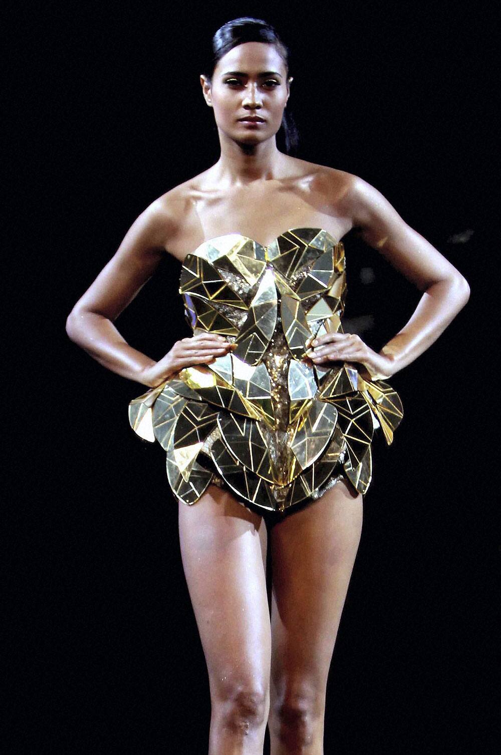 A model displays creation of Gavin Miguel during a fashion tour 2013, in Mumbai.