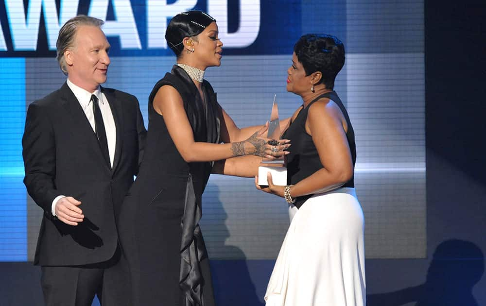 Bill Maher, left, and Rihanna's mother Monica Braithwaite, right, present the Icon award to Rihanna on stage at the American Music Awards at the Nokia Theatre L.A.