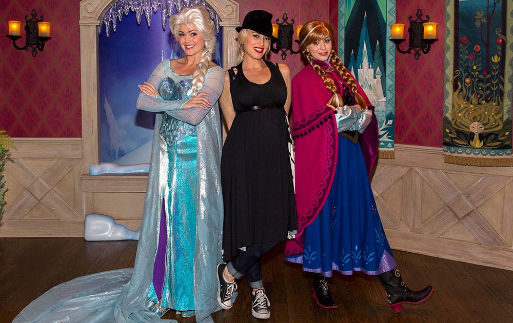 This image released by Disneyland shows musician Gwen Stefani, center, posing with women dressed as Elsa the Snow Queen, left, and Anna from the Disney animated film, 