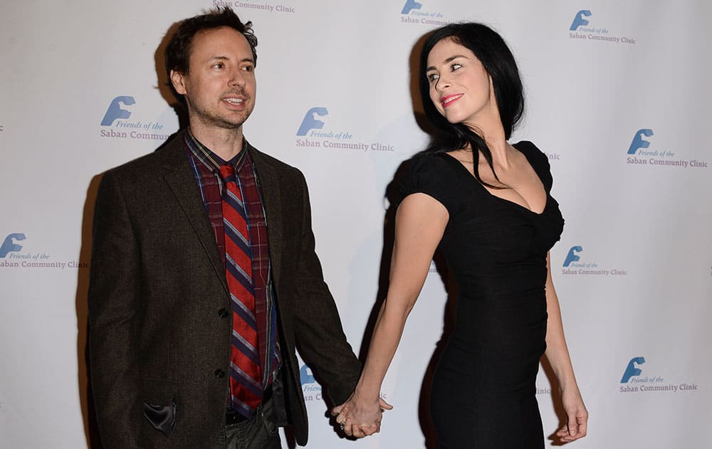 Actress and comedian Sarah Silverman, right, and comedian Kyle Dunnigan arrive at the Saban Community Clinic's benefit gala at the Beverly Hilton in Beverly Hills, Calif.