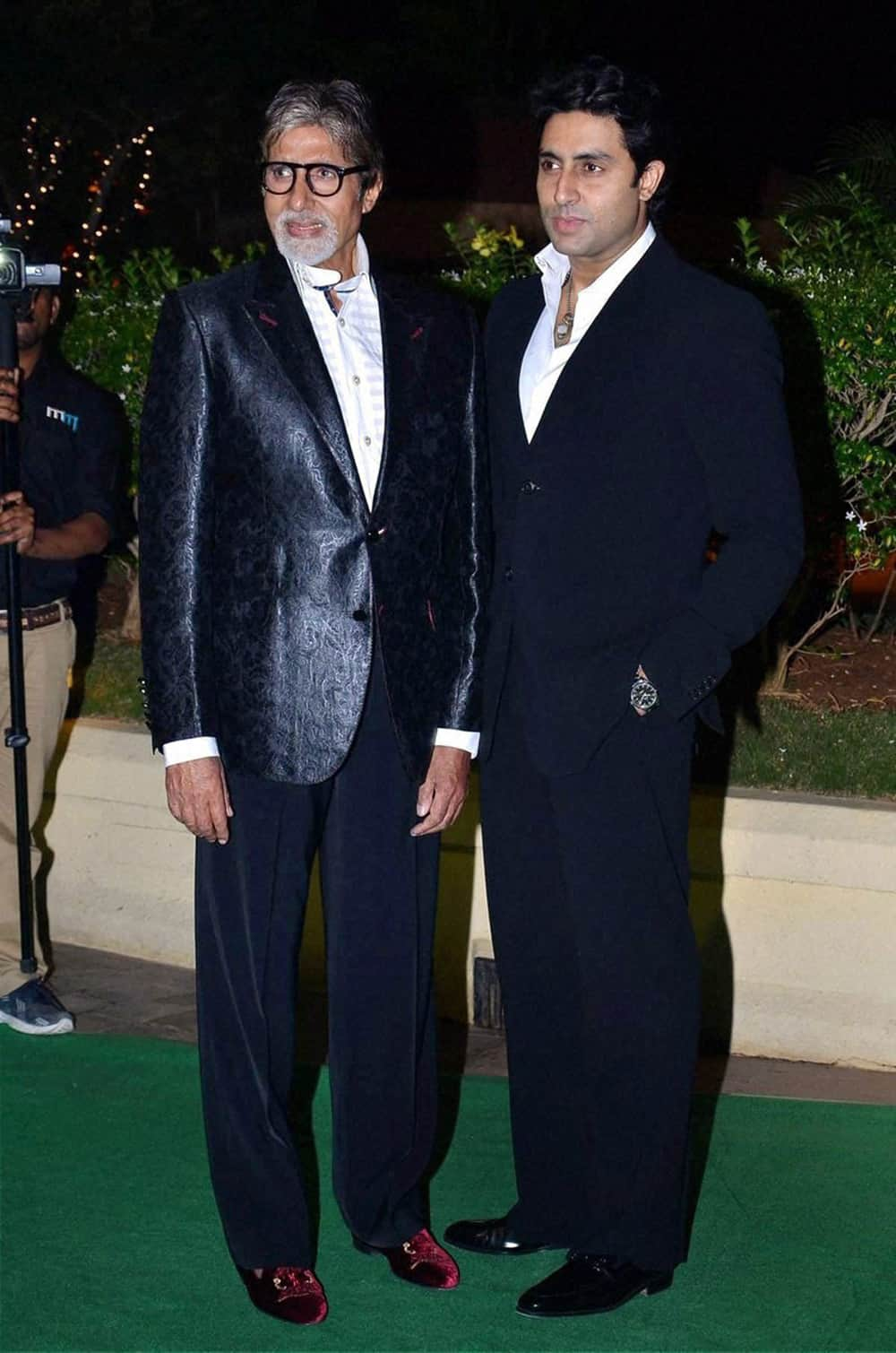 Amitabh Bachchan and Abhishek Bachchan at the wedding reception of Mahesh Bhatt's son Vishesh Bhatt in Mumbai.