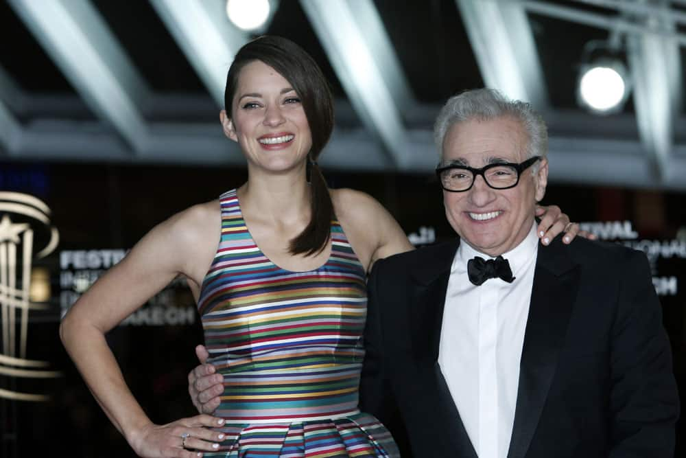 US film director Martin Scorsese and French actress and jury member Marion Cotillard pose for photographers as they arrive for a tribute to French actress Juliette Binoche at the Marrakech International Film Festival.