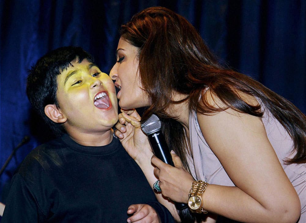 Bollywood actor Raveena Tandon with a child during an event in Mumbai.