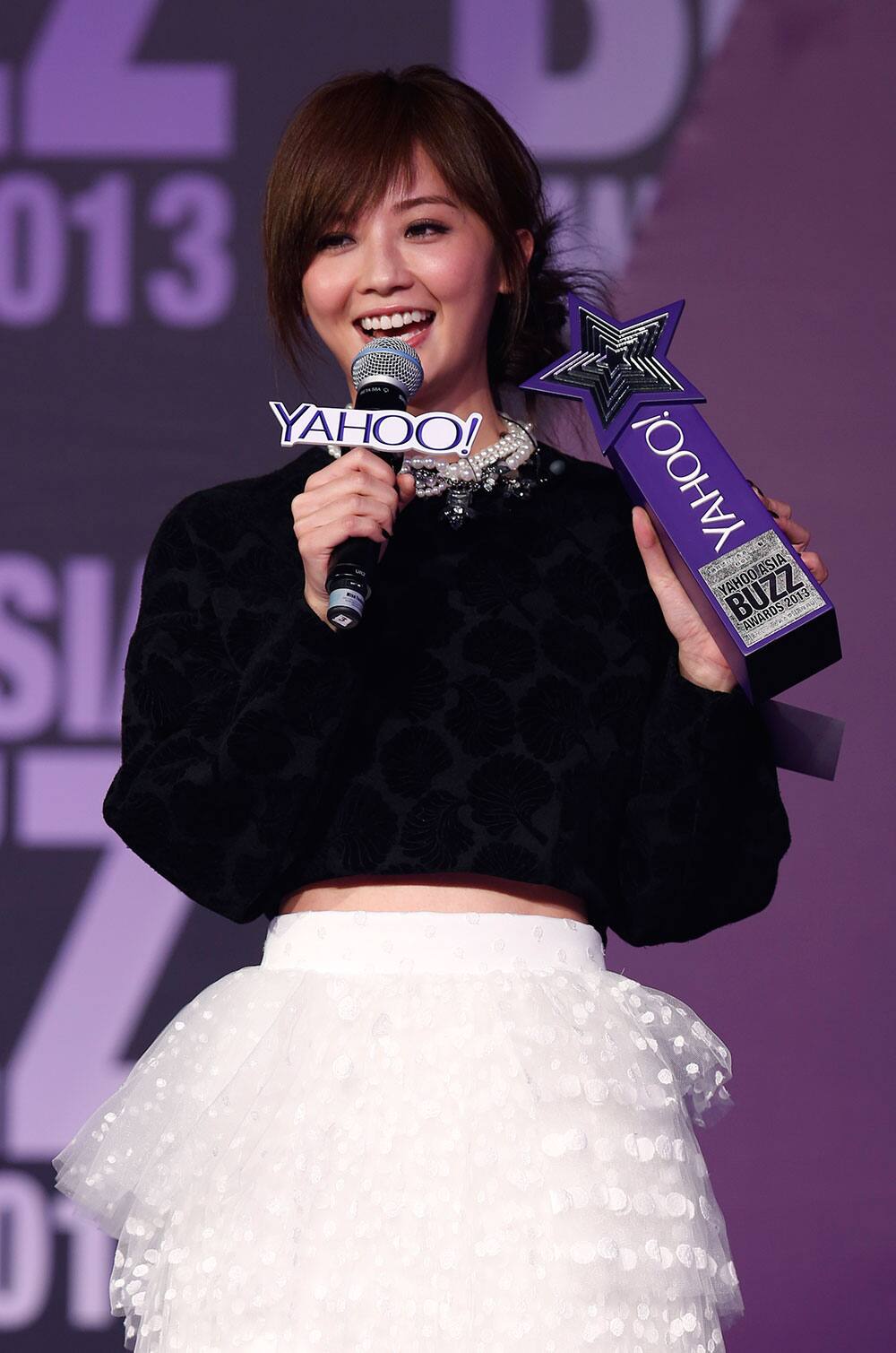 Hong Kong singer-actress Charlene Choi holds a trophy after winning the Asia's Most Influential Hong Kong actress at the Yahoo Buzz Awards in Hong Kong.