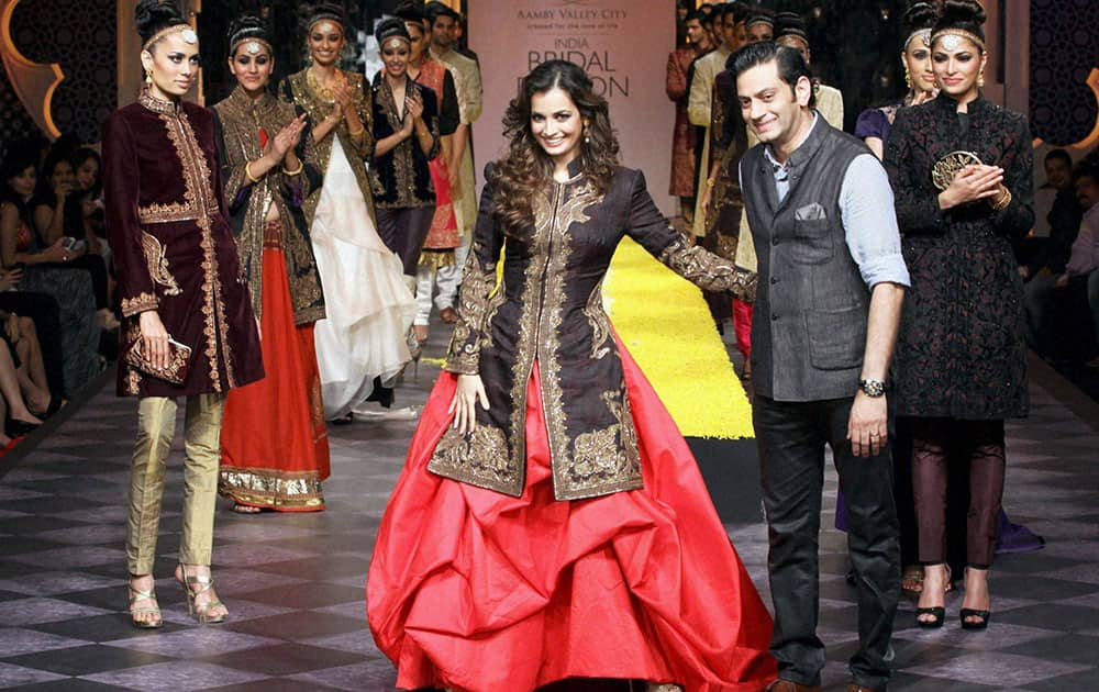 Bollywood actress Dia Mirza with designer Raghvendra Rathore during the India Bridal Fashion Week 2013 in Mumbai.