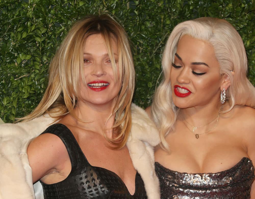 British singer Rita Ora, right, and model Kate Moss arrive at the London Coliseum for the 2013 British Fashion Awards, in central London.