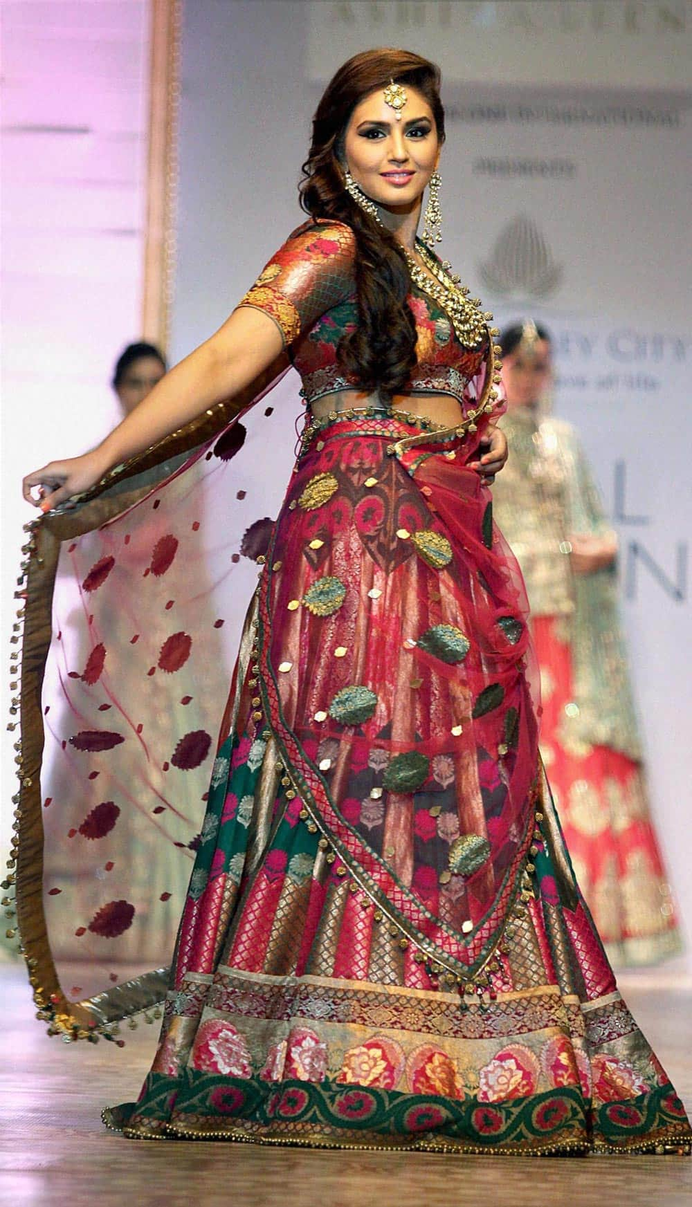 Bollywood actor Huma Qureshi walks the ramp to dispay a collection during the fourth day of India Bridal Fashion Week in Mumbai.