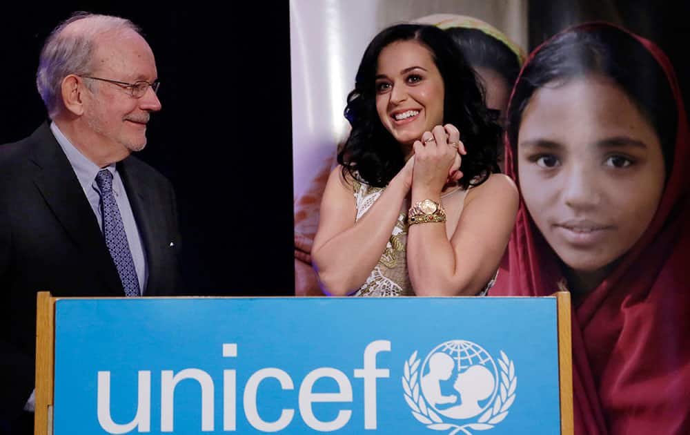 Singer Katy Perry smiles after she and UNICEF Executive Director Anthony Lake, left, signed a document appointing her a UNICEF Goodwill Ambassador at UNICEF headquarters, in New York.