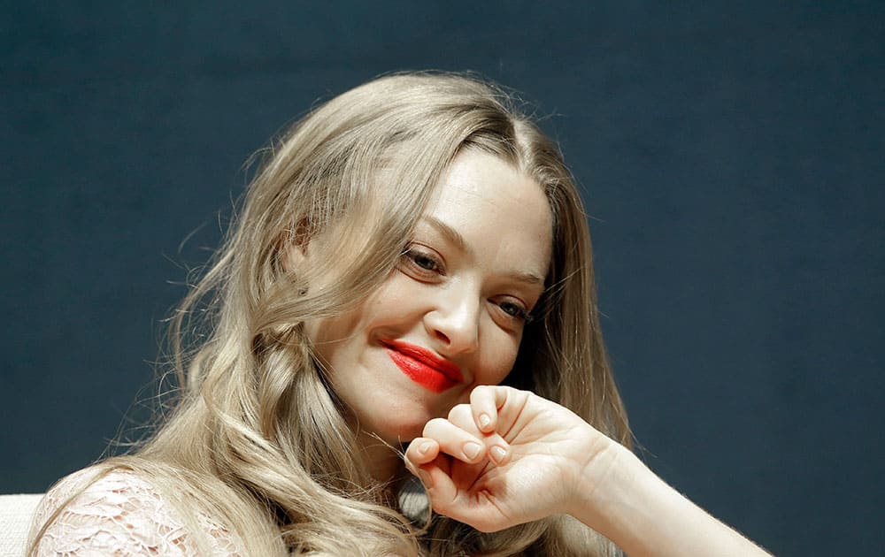 Hollywood actress Amanda Seyfried smiles as she listens to a reporter's question during a press conference in Seoul, South Korea.